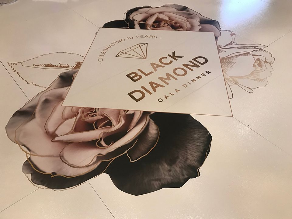 White floor with a printed floral and Black Diamond graphic