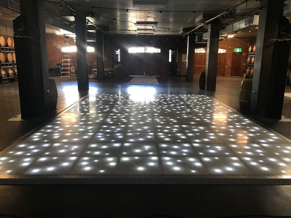 LED starlight floor glowing in a dark warehouse-style venue