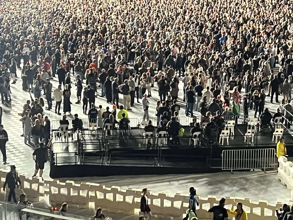 Raised, railed viewing platform with seating in the general-admission area of a stadium concert