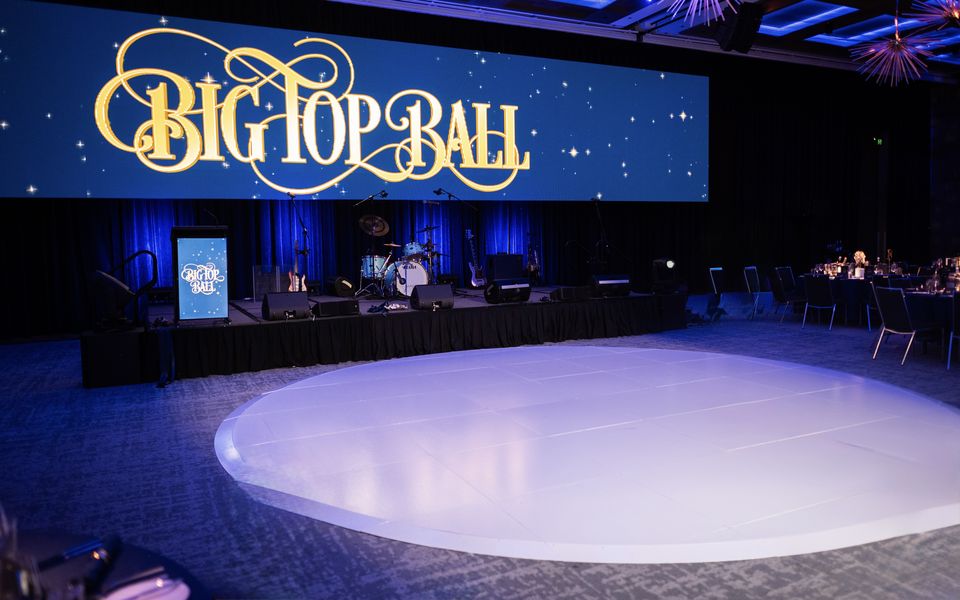Round white dance floor in a ballroom in front of a band stage